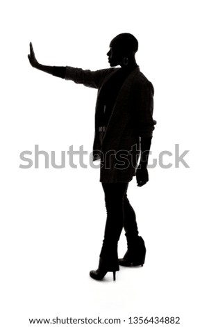 Black female African American model silhouette on a white background.  She is holding hands up in a stop gesture