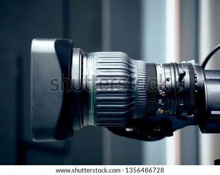 Professional digital video camera lens, studio recording equipment on details close up