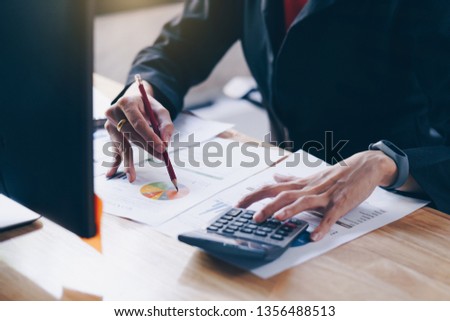 Business woman working with new startup project discussion and analysis data financial report. Using a calculator to calculate numbers.Business financial concept. Royalty-Free Stock Photo #1356488513
