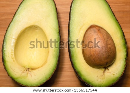 Studio shot of avocado, cut half on a cutting board