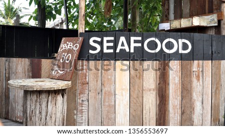 seafood BBQ sign on wooden Cerenghito