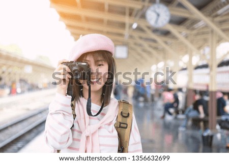 Portrait of pretty young woman having fun in the city with camera travel photo of photographer Making pictures. Travel holiday relaxation and photography concept.