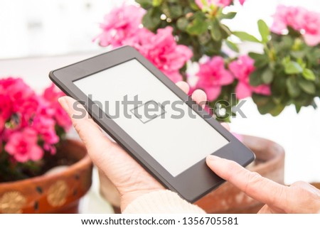 senior woman at home with digital tablet or laptop