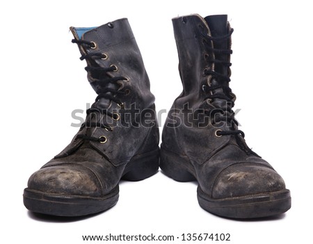 Frontal view of a very worn pair of boots, issued by the Israeli army (IDF). isolated on white background.