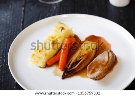 Roast duck with braised chickory and dauphinoise potatoes