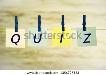 Cards hanging on a string, with the word quiz, attached with blue buckles