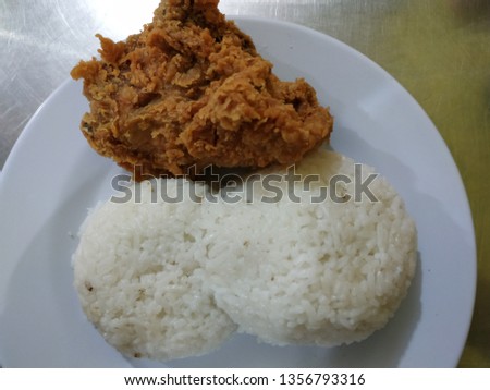 Crispy fried chicken and white rice on a white plate - picture