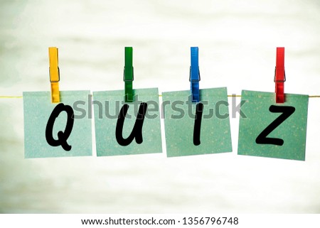 Cards hanging on a string, with the word quiz, fastened with colorful clips