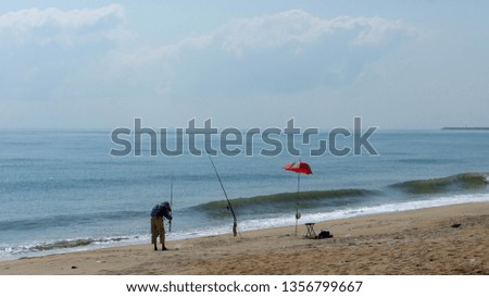 Local fisherman fishing by the beach