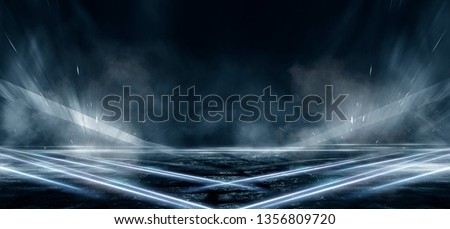 Product showcase spotlight background. Clean photography studio. Abstract blue background with rays of neon light, spotlight, reflection on the asphalt. Royalty-Free Stock Photo #1356809720