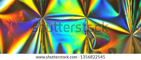 Photo of blurred holographic foil texture.
