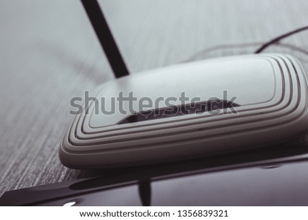 Modern White Wireless Router hanging on the wall. for technology concept Royalty-Free Stock Photo #1356839321