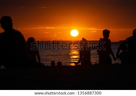 High contrast silhouettes of kids on the beach during the sunset- Isla Mujeres - Mexico.