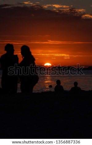 High contrast silhouettes of people on the beach during the sunset- Isla Mujeres - Mexico.