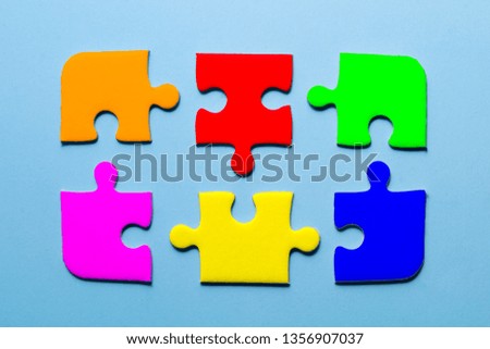 close up colorful a part of jigsaw on blue color background with concept