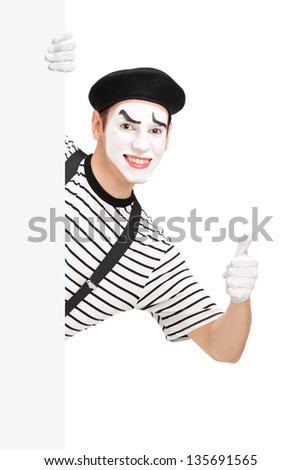 Mime dancer giving a thumb up behind a white panel, isolated on white background