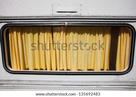 old yellow curtain in window