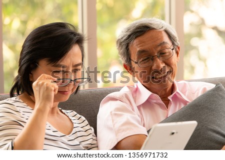 Senior couples relax on holiday in the natural living room background with modern technology