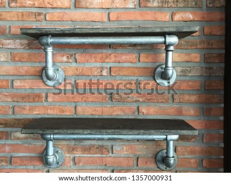 Shelf next to the brick wall