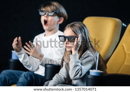 selective focus of friends in 3d glasses watching movie in cinema