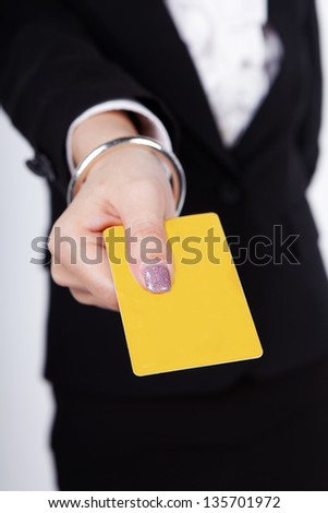 Close-up portrait of young smiling business woman holding credit card