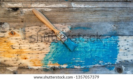 Beautiful turquoise colour and a brush on a wooden board 