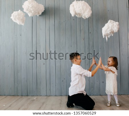 Two Caucasian siblings brother and sister posing for picture during family photo shooting