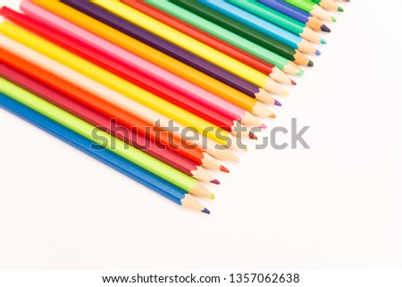 multi-colored pencils for drawing children in school and kindergartens on a white background