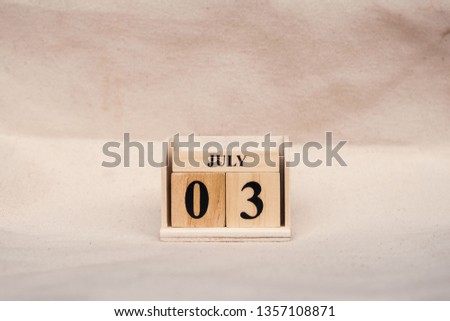 July 3rd. Image of July 3 wooden color calendar on white canvas background. empty space for text