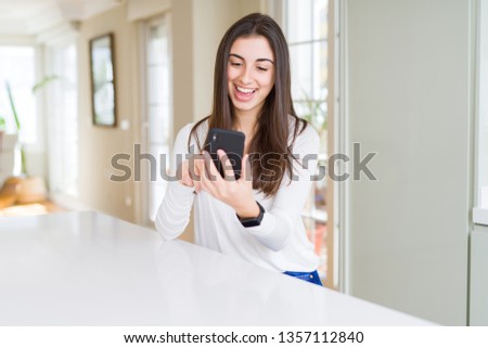 Young woman using smartphone, smiling happy texting and typing