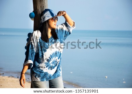 Traveler thai women relax lonely and posing for take photo on Phum Riang Beach in Ao Thai or Gulf of Thailand at Chaiya District in Surat Thani, Thailand