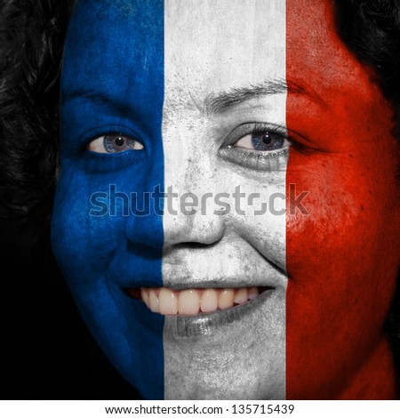 Woman with flag painted on her face to show France support in sports
