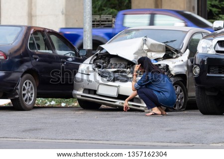 Asian upset driver woman in front of automobile crash car collision accident in city road