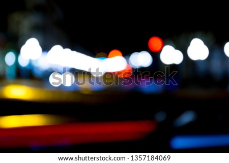 abstract traffic lights on urban street at night, abstract bokeh, blurred motion