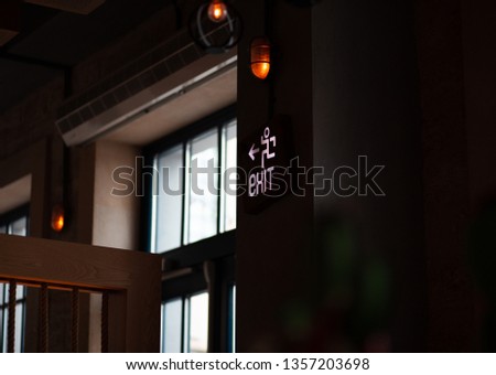 emergency light wall panel and exit sign in the restaurant. Emergency door.   Royalty-Free Stock Photo #1357203698
