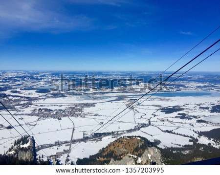 Scenic view: Tegelberg Cable Car (Tegelbergbahn). View of Füssen (Fuessen), Schwangau, Hohenschwangau, Neuschwanstein. Winter wonderland, snow, blue sky, horizon (Bavaria, Allgäu, Allgau, Germany)