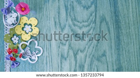 Easter card, on a background of blue wood with flowers and decoration.