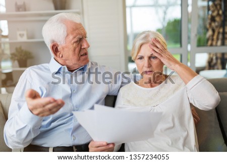 Senior couple looking through bills
 Royalty-Free Stock Photo #1357234055