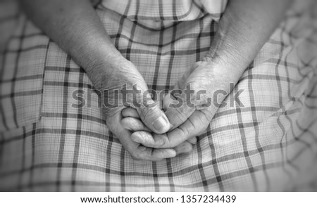 Close up old hands woman is sitting alone in nursing home.