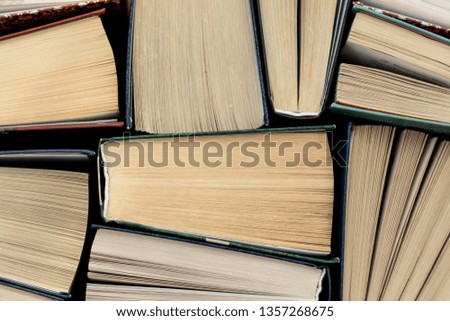 Many Books Piles. Hardback books on wooden table.
