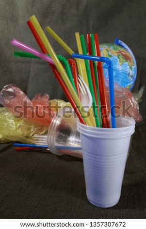 White disposable plastic and plastic straws for drinks. Say no to the disposable. The concept of environmental pollution.