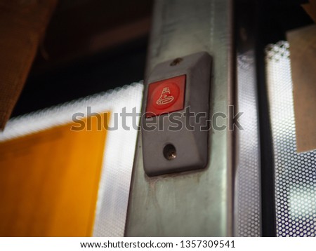 low angle of red stop button on bangkok bus