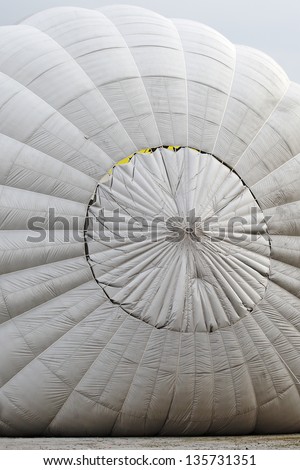 Inflating a white color hot air balloon.
