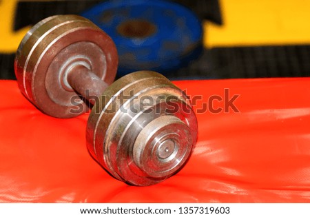 Separate metal dumbbell lying in the gym