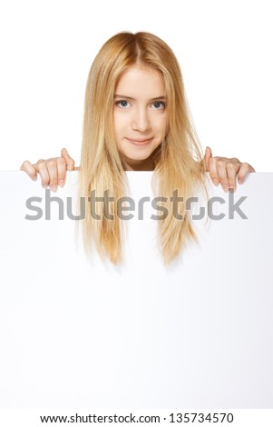 Young beautiful teenage girl smiling showing blank white placard isolated on white background