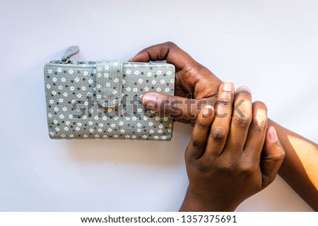 African American woman holding beautiful  fashionable floral purse in hands isolated on white background for banking, savings money and personal finance concept