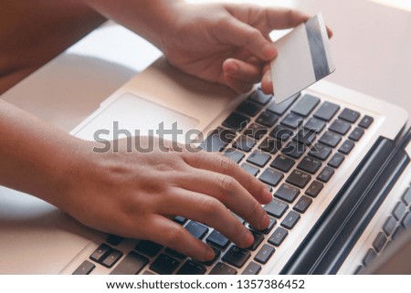 woman hand holding credit card and using laptop making online. payment online, online shopping