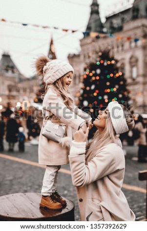 Mother and daughter are walking around the city on Christmas and New Year holidays, noise effect
