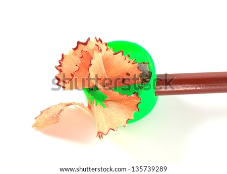 close up of pencil shavings and sharpener on white background