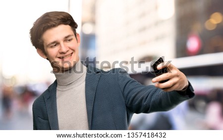 Teenager man with turtleneck making a selfie at outdoors
